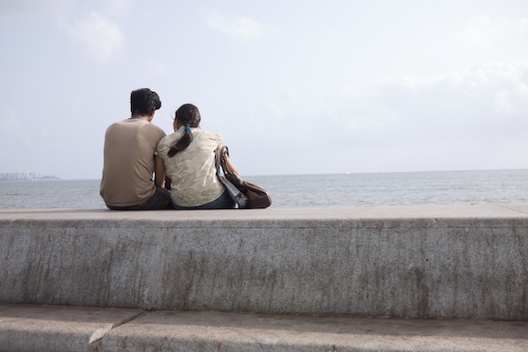 A couple sitting together on Marine Drive in Mumbai, India