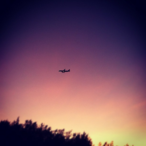 [Photo] Airplane at sunset, landing in Cairns International Airport, as seen from Yorkey's Knob Beach, QLD, Australia.